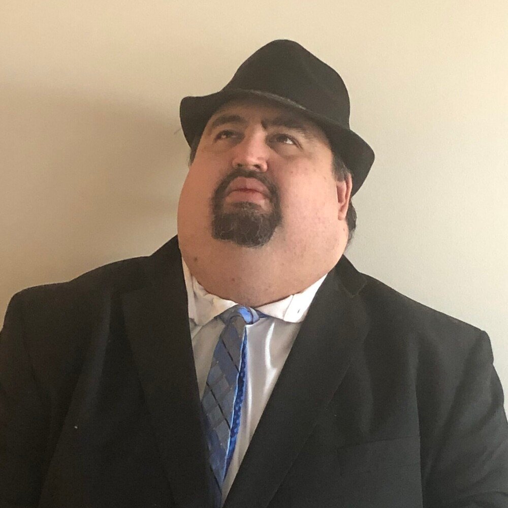 Daniel Hodges dressed in a suit and wearing a fedora